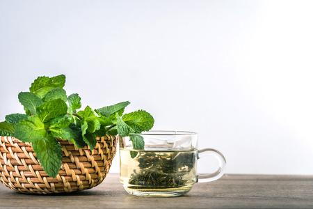 Close up glass cup of mint tea with green fresh peppermint leaves , relaxation and healthy drinkの写真素材