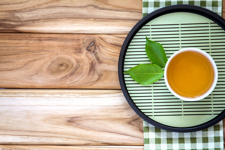 Top view or overhead shot of a cup of tea decoration on wooden background ,Japanese organic tea style concept.の写真素材