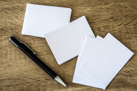 stacking of mockup empty white business card with elegance pen  on wooden background , template for business  branding identity designの写真素材