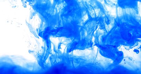 Close up a blue colored drop in the water, abstract motion movement of watercolor ink splashing as frame border backgroundの写真素材