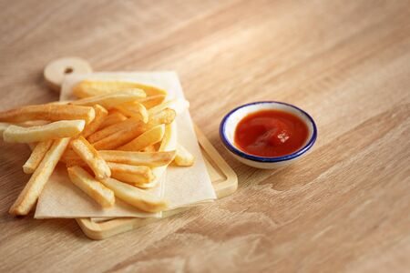 Close up French Fries with a tomato sauce on the table, fatty unhealthy  junk food conceptの写真素材