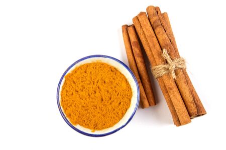 Close up the brown cinnamon stick and powder  isolated on white background , overhead and top viewの写真素材