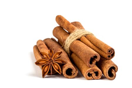 Close up brown cinnamon stick with star anise spice isolated on white background の写真素材