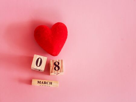decoration of wooden date blog cube for 8 March , international women's day with red heart shape on pink for celebration conceptの写真素材