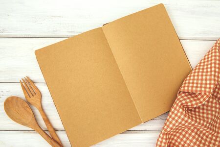 brown recipe cooking book on white wooden bordの写真素材
