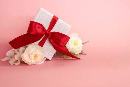  gift box with red bow on pink background . valentine 's or Mother's or Women 's  day celebration conceptの写真素材
