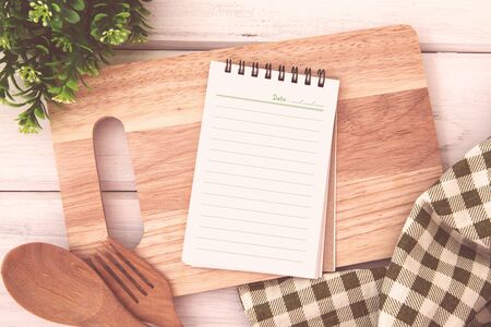 brown recipe cooking book on white wooden bordの写真素材