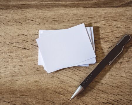 stacking of mockup empty white business card with elegance pen  on wooden background , template for business  branding identity designの写真素材
