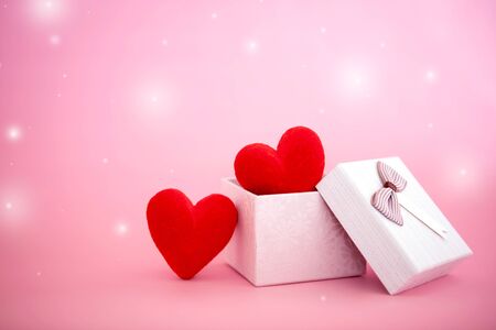 The red Heart shapes  in gift box on sweet pink background , love concept for valentines day with sweet and romantic momentの写真素材