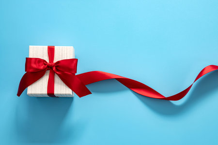  gift box with red bow on blue background . Happy Father's or Mother's or Women 's  day celebration...