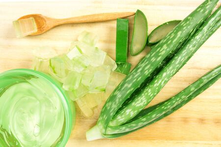 sliced and leaf of fresh aloe vera on  wooden plate , natural clear gel as the star beauty ingredient  for skin careの写真素材