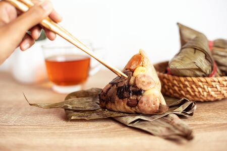 Close up Zongzi or rice dumpling on wooden table with Chinese tea in Dragon Boat Festival, Asian traditional food の写真素材
