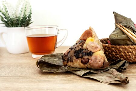 Close up Zongzi or rice dumpling on wooden table with Chinese tea in Dragon Boat Festival, Asian traditional food の写真素材