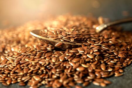  flax seed in wooden spoon , super food with hight of fiber nutrient and anti inflammatory omega-3 fatty acidsの写真素材