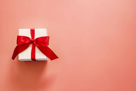 gift box with red bow on pink background . valentine 's or Mother's or Women 's  day celebration conceptの写真素材