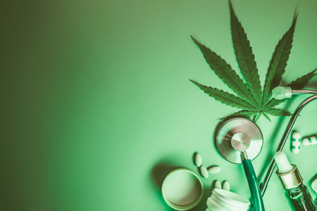 Marijuana leaf with drug capsule and stethoscope on light green background , Medical drug using of marijuana cannabis plant product conceptの写真素材