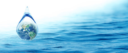 World Water day concept with world in clean water drop on and fresh blue water ripples design, Environment save and ecology theme conceptの写真素材