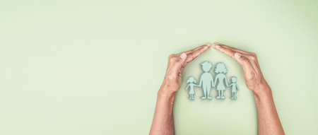Hand holding covered 3d family symbolic icon, planning family protection by or family care and support conceptの写真素材