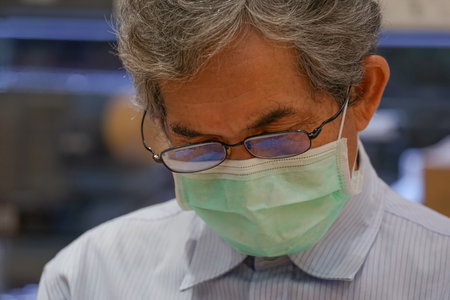 portrait an old man wear protective face mask and eyeglasses background blurred concept the new...