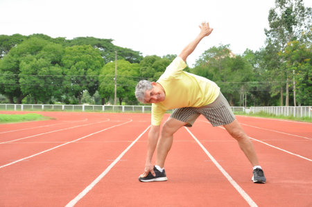 an old man warming up exercise before running or jogging, concept health care in elderly people