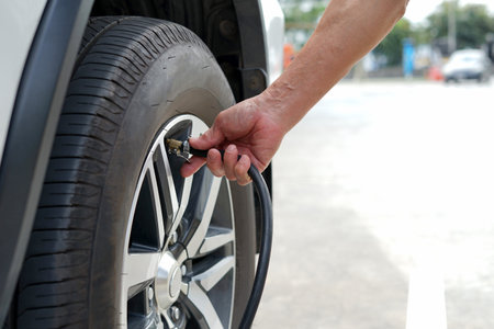 a senior man hand inflate car tire to ensure to drive, concept risk management and safety to use a...