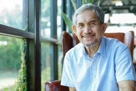 portrait elderly retired man sitting casually in cafe indoor