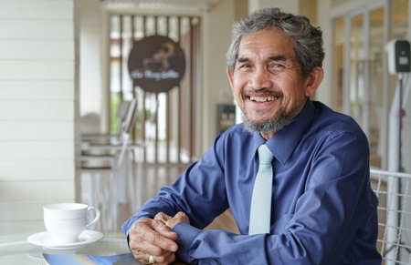 portrait a senior businessman sitting in urban lifestyle cafe,concept elderly business...