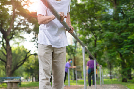 senior man with movement disability try to walking by himself on concrete stone floor, older adult...