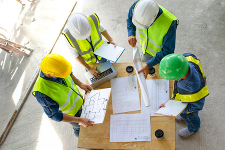engineering teamwork meeting on site work,engineers project manager consultation meeting with coworker.concept of engineering or architecture working outdoors for a new real estate home projectの写真素材