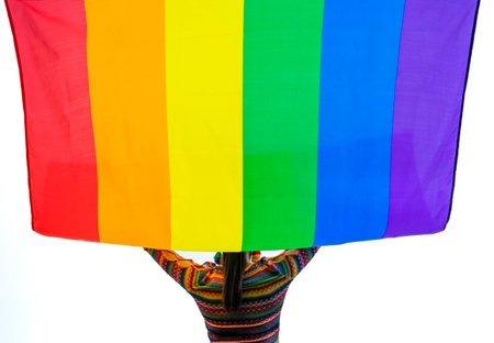 colorful lgbt rainbow flag being raised up by silhouette of woman transgender,isolated on white background, selective focus.concept of support community equality movement lgbtq, lgbt happy pride monthの写真素材