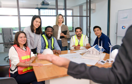 group of multiethnic colleagues,engineers,architects and employee smiling and concentrate to a speaker while presenting progress of a new project, engineering internal inspector meetingの写真素材