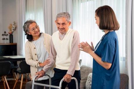 an elderly man patient being assist by home health nurse,using walker to walk at home,a senior...