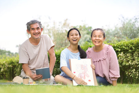 grandfather,grandmother and granddaughter enjoy leisure time together in the park,grandchild...