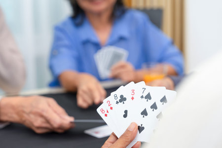 group of active senior pensioners playing cards game together, concept elderly retired people...