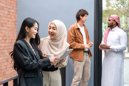 group of cheerful multi ethnic friends,students on a campus enjoy talking together during taking breakの写真素材