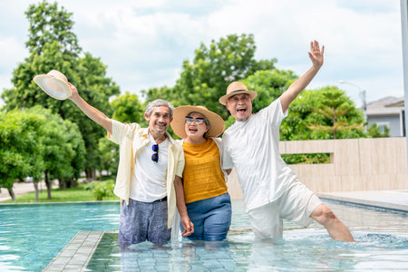 portrait cheerful elderly friends at the pool,senior pensioner people trip at spa resort on summerの写真素材