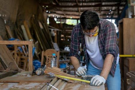 modern caucasian craftsman using tablet computer doing DIY wood furniture and repair woodcraft at the carpentry workshopの写真素材