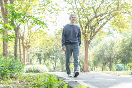 active asian senior man walking in the park,elderly lifestyle,exercisingの写真素材