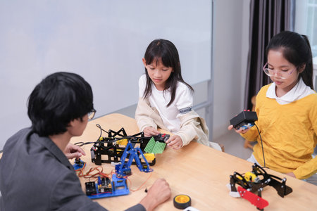 children working on circuit boards of small robot at technology and engineering workshop,elementary children learning STEM Education in school classの写真素材