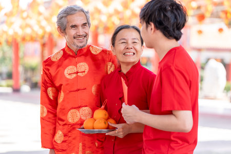 portrait happy asian family with worship things in chinese shrine,concept for holiday celebration,chinese new year traditionalの写真素材