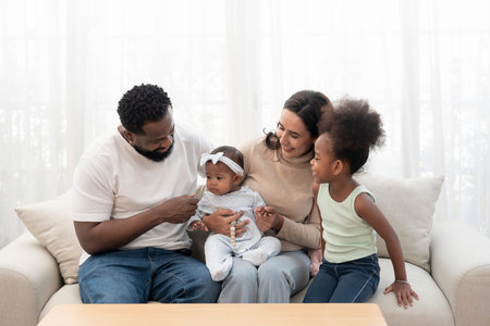 scene of bonding interracial family spend free time together in the living room,cozy home,domestic lifeの写真素材