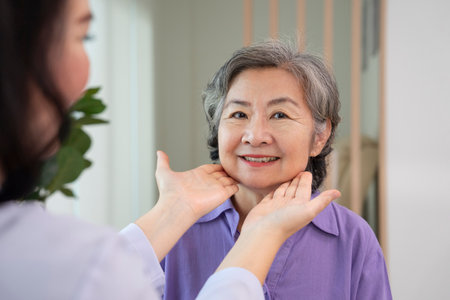 asian senior woman smile when cosmetologist touching her face to check her facial skin condition for cosmetic treatment at aesthetic clinicの写真素材