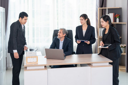 cheerful senior boss during business meeting,employees having conference in boardroom,conversation,consulting,discussingの写真素材