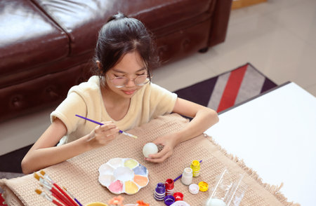 A girl paint eggs for easter celebration at home,traditional seasonの写真素材