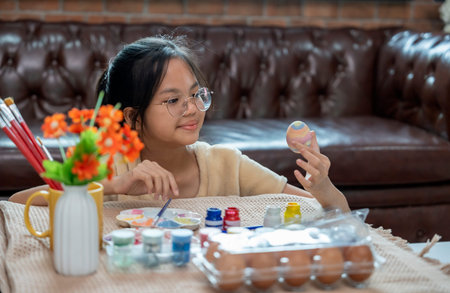 A girl paint eggs for easter celebration at home,traditional seasonの写真素材