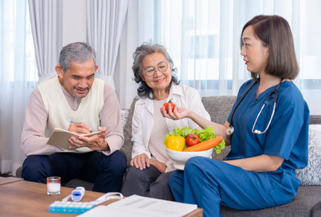 home health care nurse in uniform explaining nutritional value of fruits,vitamins and dietary fiber to senior couple,old man writing on notebookの写真素材