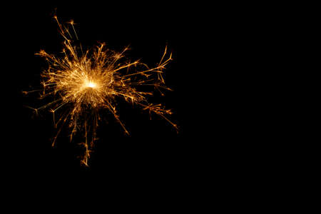 A picture of a real sparkler set against a black backgroundの写真素材