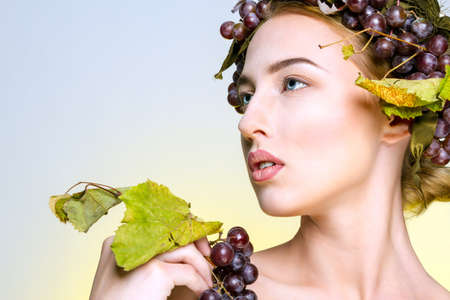 The girl with grapesの写真素材