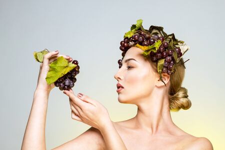 Young woman with grapesの写真素材