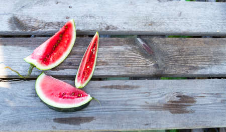 Ripe sliced ??watermelon on a gray wooden board.の写真素材